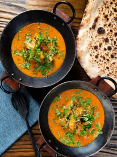 Overhead Indian coconut milk chicken curry with tamarind and fresh coriander.