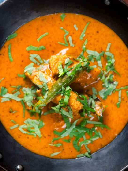 Overhead close-up Indian coconut milk chicken curry with tamarind and fresh coriander.