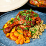 Duck leg tagine with Moroccan flavours served with buttered couscous and fresh coriander.