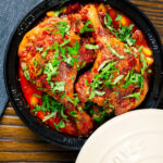 Overhead duck leg tagine with Moroccan flavours served in a tagine.