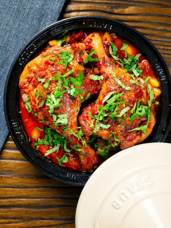 Overhead duck leg tagine with Moroccan flavours served in a tagine.