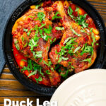Overhead duck leg tagine with Moroccan flavours served in a tagine featuring a title overlay.