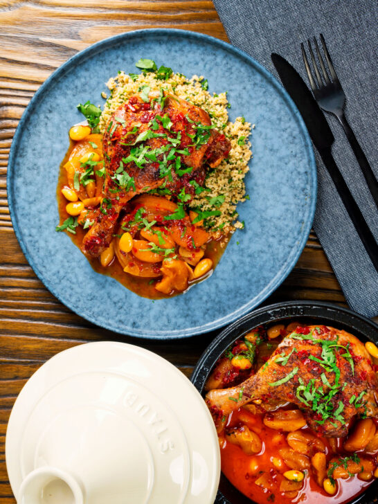 Overhead duck leg tagine with Moroccan flavours served with buttered couscous and fresh coriander.