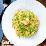 Overhead prawn pesto pasta with linguine and fresh basil featuring a title overlay.