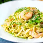 Prawn pesto pasta with linguine and fresh basil.