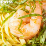 Close-up prawn pesto linguine with fresh basil chiffonade featuring a title overlay.