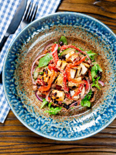 Overhead grilled and marinated halloumi salad with peppers, couscous and chickpeas.