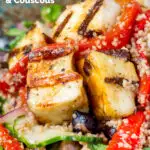 Close-up grilled and marinated halloumi salad with peppers, couscous and chickpeas featuring a title overlay.