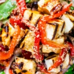 Overhead close-up grilled and marinated halloumi salad with peppers, couscous and chickpeas.