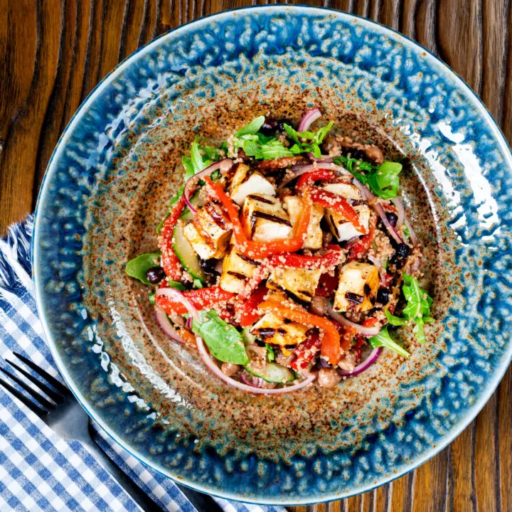 Grilled halloumi cheese salad with pomegranate molasses, couscous and chickpeas.