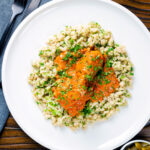 Overhead Hungarian chicken paprikash in a sour cream and paprika sauce with dumplings.