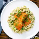 Overhead Hungarian chicken paprikash in a sour cream and paprika sauce with dumplings featuring a title overlay.