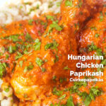 Close-up Hungarian chicken paprikash or csirkepaprikás in a paprika sauce with nokedli featuring a title overlay.