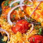 Close-up Indian influenced one pot baked chicken legs and basmati rice.