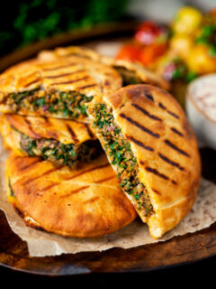 Minced lamb arayes stuffed pita breads served with batata harra.