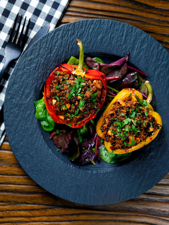 Overhead minced lamb stuffed peppers with almonds and couscous.