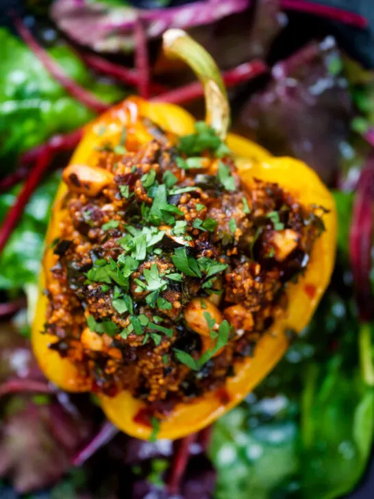 Overhead close-up minced lamb stuffed peppers with almonds and couscous.