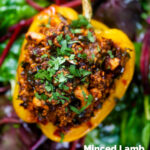 Overhead close-up minced lamb stuffed peppers with almonds and couscous featuring a title overlay.