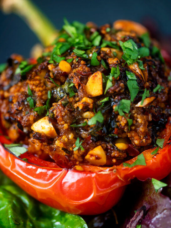 Close-up minced lamb stuffed peppers with almonds and couscous.