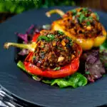 Minced lamb stuffed peppers with almonds and couscous featuring a title overlay.