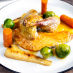 Roast guinea fowl with honey glazed vegetables featuring a title overlay.