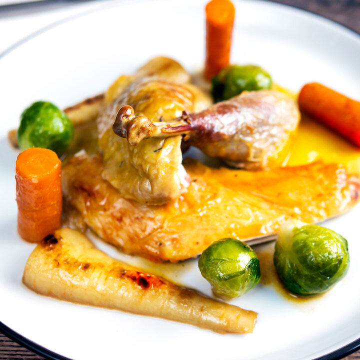 Carved roast guinea fowl served with honey glazed vegetables.