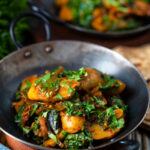 Indian spinach and potato curry or saag aloo served with homemade chapatis.