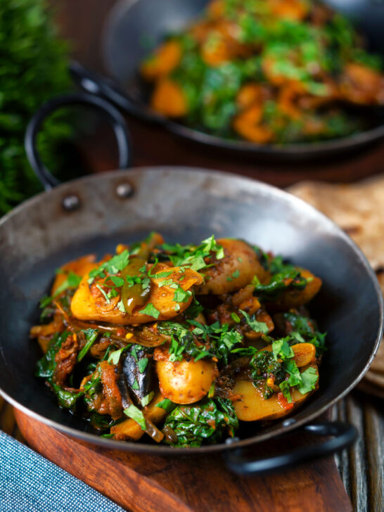 Indian spinach and potato curry or saag aloo served with homemade chapatis.