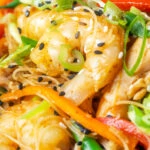 Close-up curried Singapore chow mein noodles with chicken and prawns.
