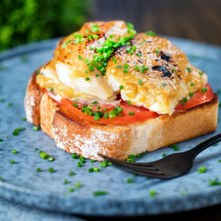 Smoked haddock rarebit on toast with beef tomatoes and snipped chives.