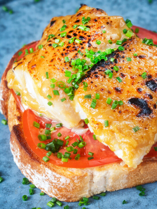 Smoked haddock Welsh rarebit on toast with beef tomatoes and chives.