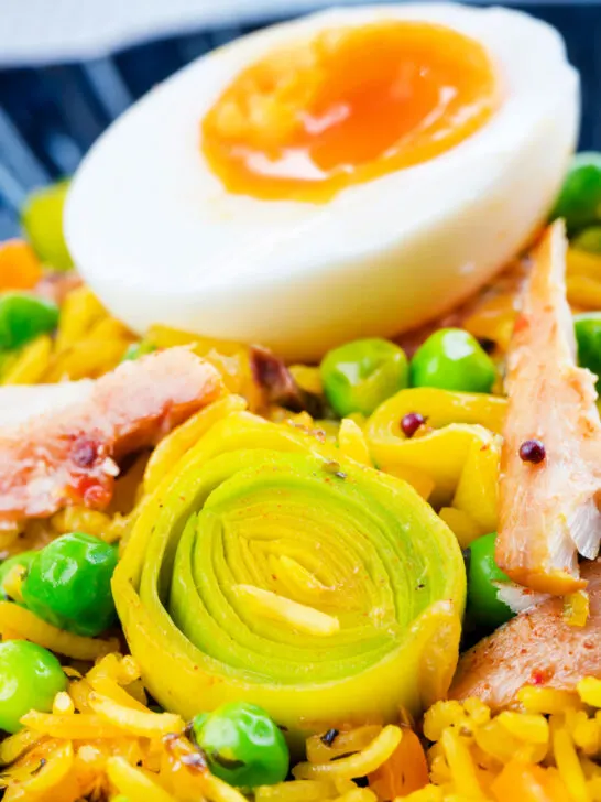 Close-up smoked mackerel kedgeree with leeks, peas topped and a boiled egg.