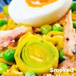 Close-up smoked mackerel kedgeree with leeks, peas topped and a boiled egg featuring a title overlay.