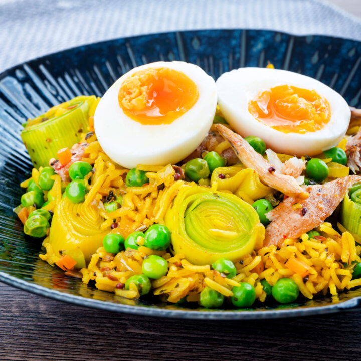 Anglo Indian smoked mackerel kedgeree with leeks and peas topped with a boiled egg.