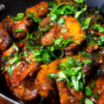 Close-up vegan spinach and mushroom Indian inspired curry.