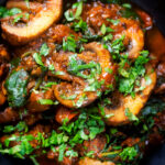 Overhead close-up vegan spinach and mushroom Indian inspired curry.