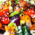 Close-up vegan sweet and sour tofu with pineapple and veggies.