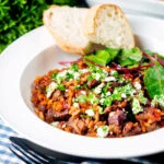 Greek baked youvetsi or giouvetsi with lamb and orzo in tomato sauce.