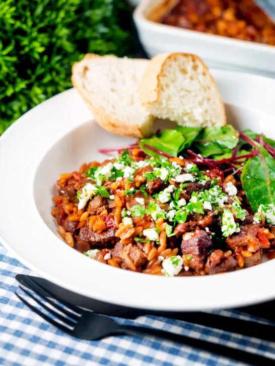 Greek baked youvetsi or giouvetsi with lamb and orzo in tomato sauce.