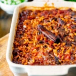 Greek baked youvetsi or giouvetsi with lamb and orzo in a baking dish.