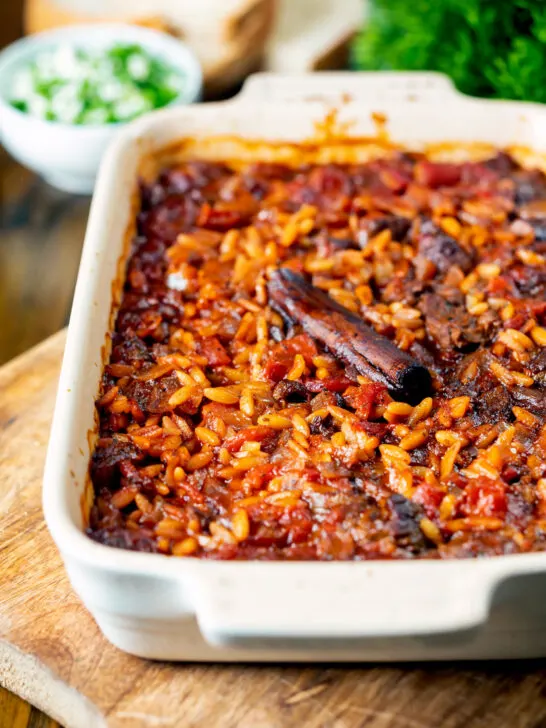 Greek baked youvetsi or giouvetsi with lamb and orzo in a baking dish.