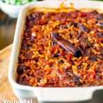 Greek baked youvetsi or giouvetsi with lamb and orzo in a baking dish featuring a title overlay.