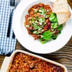 Overhead Greek baked youvetsi or giouvetsi with lamb and orzo in tomato sauce.