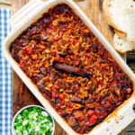 Overhead Greek baked youvetsi or giouvetsi with lamb and orzo in a baking dish.