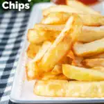 Close-up air fryer golden crispy British chips served with a bowl of ketchup featuring a title overlay.