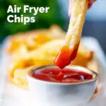 British style air fryer chips with one being dipped into tomato ketchup featuring a title overlay.