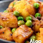 Close-up aloo gobi matar an Indian potato, cauliflower and pea curry featuring a title overlay.
