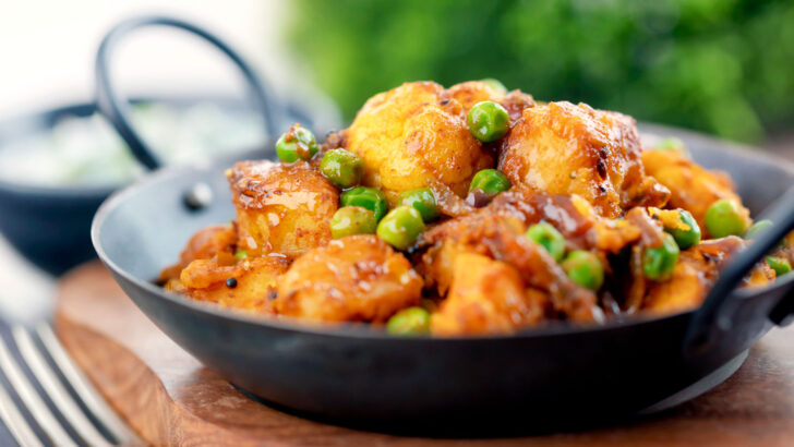 Vegan aloo gobi matar or Indian potato, cauliflower and pea curry.