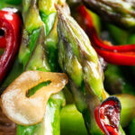 Close-up asparagus stir fry with soy sauce garlic and chilli.
