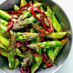 Overhead asparagus stir fry with soy sauce garlic and chilli.
